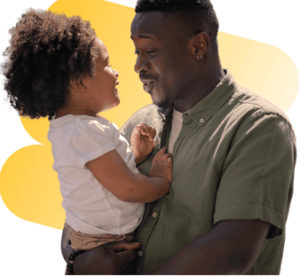 Father holding toddler in arms